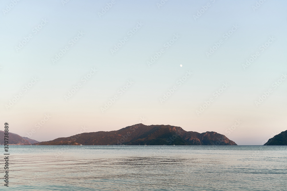 Panoramic photo of sea and hills in dusk. Traveling to nature