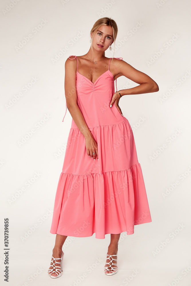 Beautiful woman fashion model makeup brunette hair perfect body shape tanned skin wear clothes summer collection organic long pink silk dress stylish sandals shoes, accessory jewelry earrings date. Beautiful woman fashion model makeup brunette hair perfect body shape tanned skin wear clothes summer collection organic long pink silk dress stylish sandals shoes, accessory jewelry earrings date.