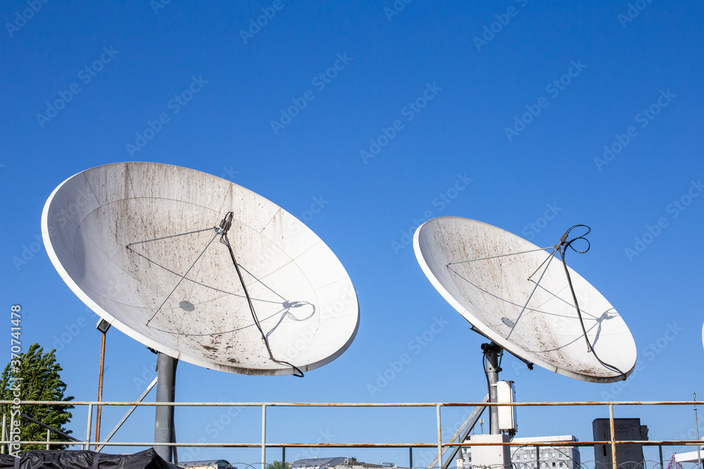 A group of dirty satellite dishes. Satellite dish is a dish-shaped type of parabolic antenna designed to receive or transmit information by radio waves to or from a communication satellite. A group of dirty satellite dishes. Satellite dish is a dish-shaped type of parabolic antenna designed to receive or transmit information by radio waves to or from a communication satellite.