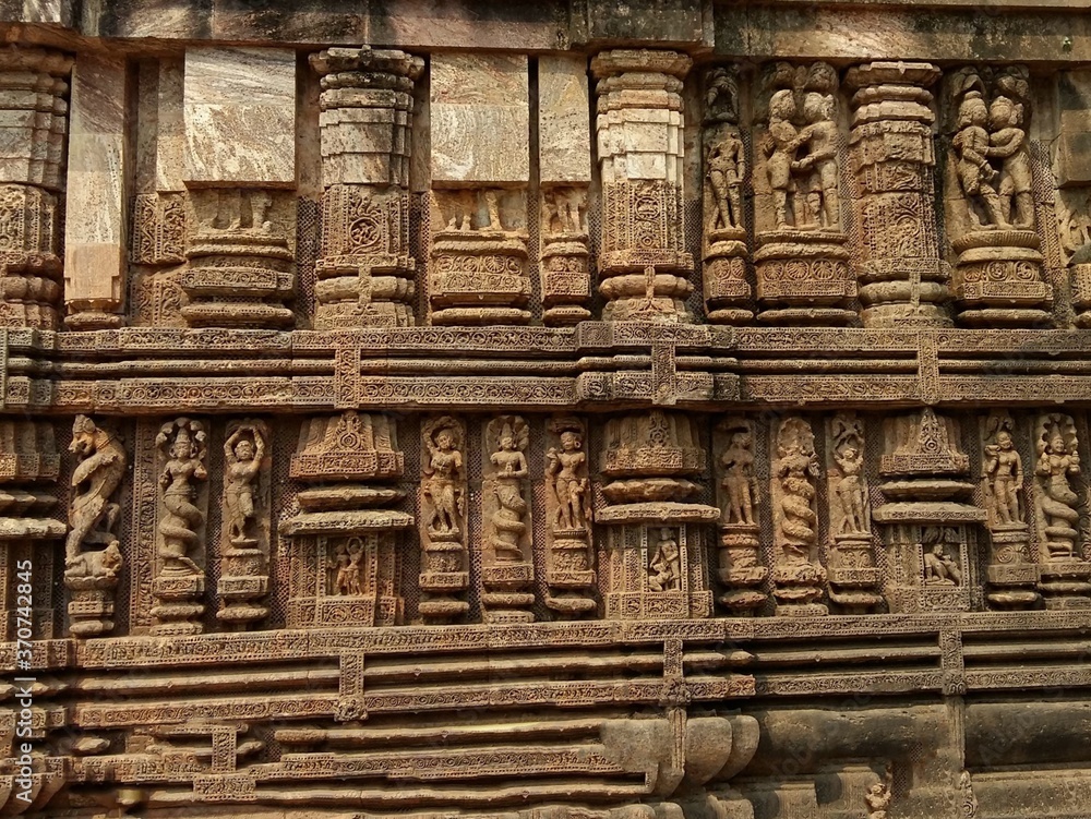 Sun Temple of Konark, India. Rock cut wall art on walls of the temple, sculptures of foreplay, mythical characters,and dance are carved out of stone.