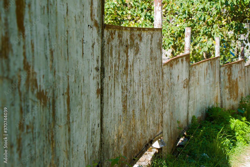 Old village house fence, road and plants Old village house fence, road and plants