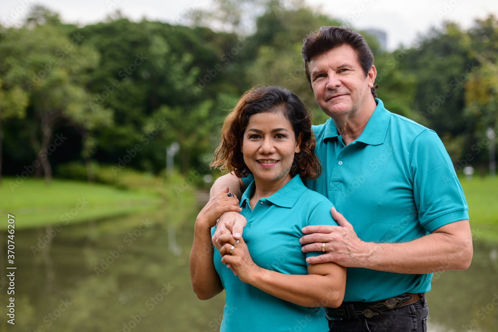Happy mature multi ethnic married couple together and in love at the park Happy mature multi ethnic married couple together and in love at the park