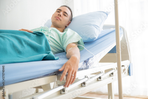 Young Man Lying On Bed At Hospital