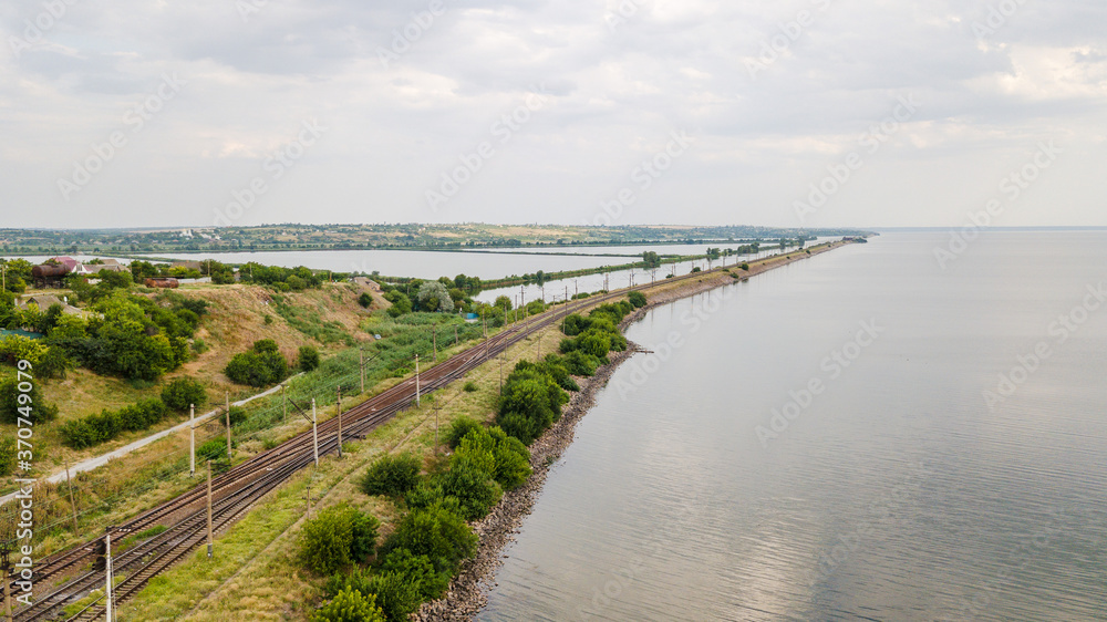 Aerial view of train railway over the river in Ukraine Top view of railroad from drone.