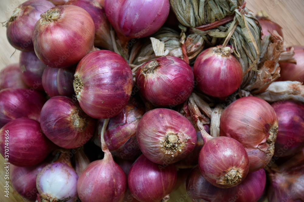 Red onion placed on a wooden floor Red onion placed on a wooden floor