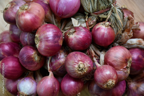 Red onion placed on a wooden floor