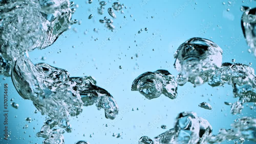 Macro shot of various air bubbles in water rising up on light blue background. Super slow motion filmed on high speed cinema camera at 1000 fps. Macro shot of various air bubbles in water rising up on light blue background. Super slow motion filmed on high speed cinema camera at 1000 fps.