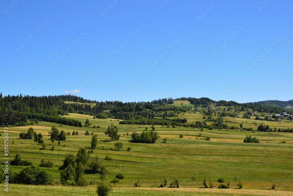 Podhale, Poland. Beautiful landscape, panorama. Idyllic view with green hills, fields and meadows.