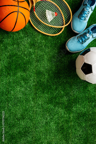 Fototapeta Naklejka Na Ścianę i Meble -  Frame of sport balls - football, basketball on football field. Copy space