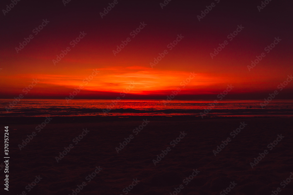 Ocean beach with waves and reflection at sunset or sunrise in Bali. Ocean beach with waves and reflection at sunset or sunrise in Bali.