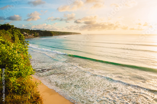 Fototapeta Naklejka Na Ścianę i Meble -  Coastline with beach, waves for surfing and warn sunlight at Bali