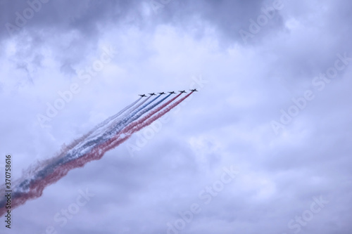 Military aircraft of Russian armed forces fly in sky with texture clouds. Plane is flying. Naval parade. Day of Navy Russia. Naval parade. Holidays of Saint Petersburg  Russia. Rehearsal of parade