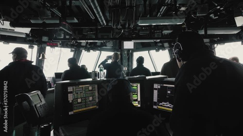 Crew working on navy ship bridge photo