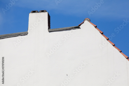 Dach, Schornstein, weisse Hauswand, Dachkante, Blauer Himmel photo