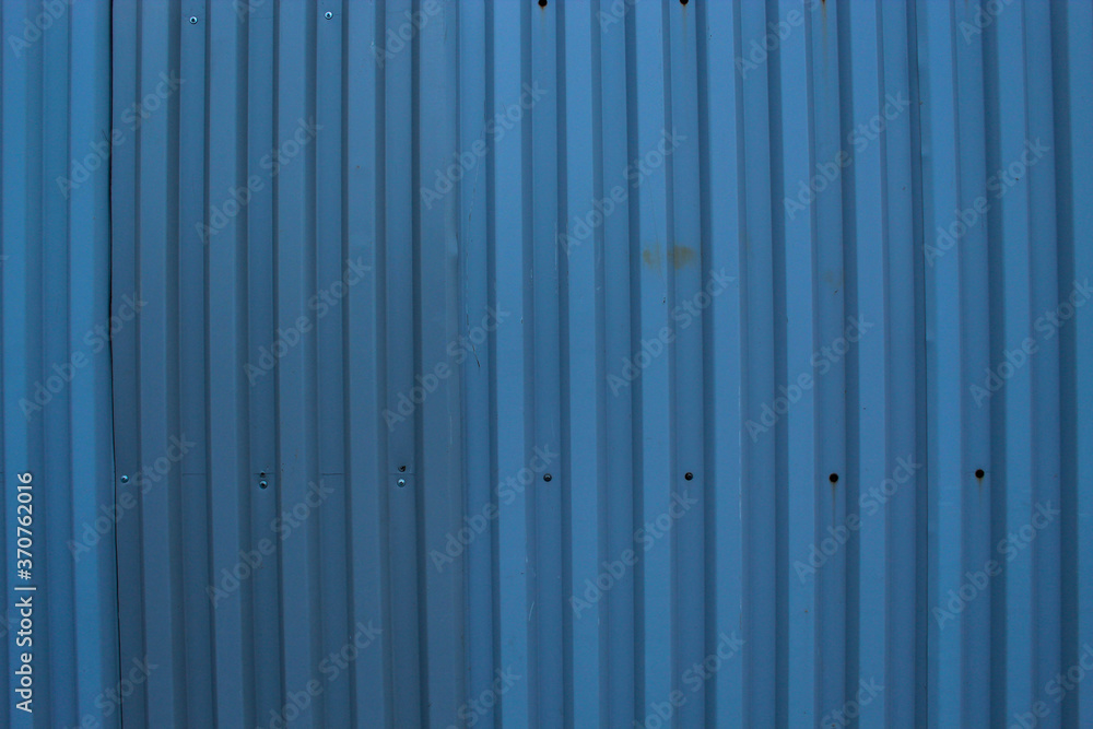 A metal grey fence, a natural abstract background gray light blue color A metal grey fence, a natural abstract background gray light blue color