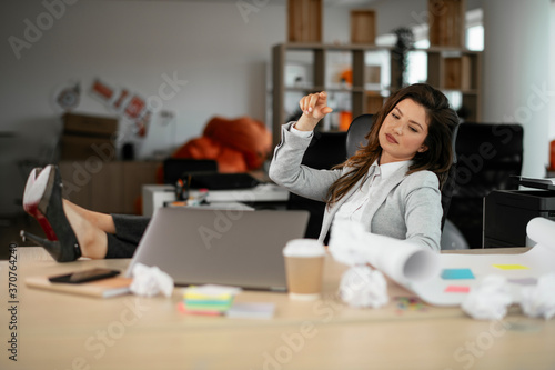 Businesswoman celebrating wining a new project. Beautiful woman working on project..