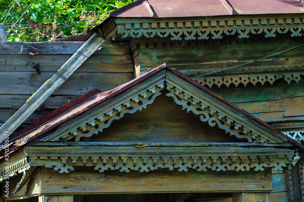 Window of old traditional russian wooden house. Building, roof.
