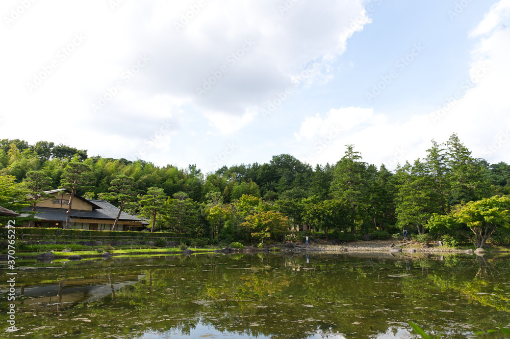 HDR natural Japanese style decoration park and garden decorated greenery tree, Japanese style house and bush with its mirror reflection on clear water pond. HDR natural Japanese style decoration park and garden decorated greenery tree, Japanese style house and bush with its mirror reflection on clear water pond.