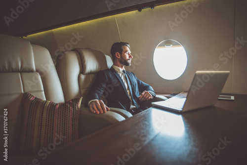 Businessman flying on his private jet photo