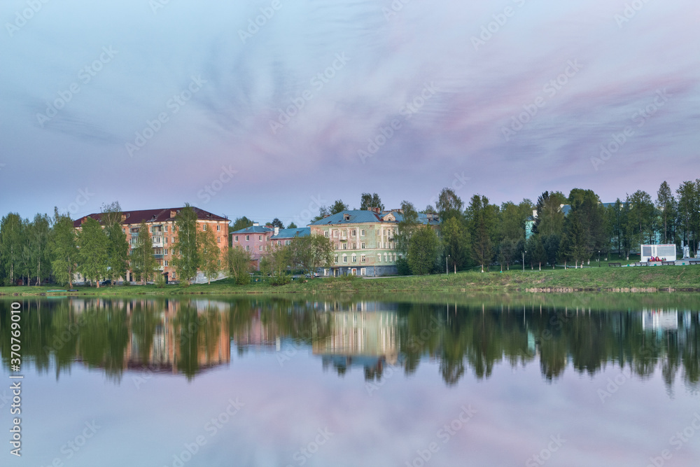 Fototapeta premium reflection of houses in a pond at sunset
