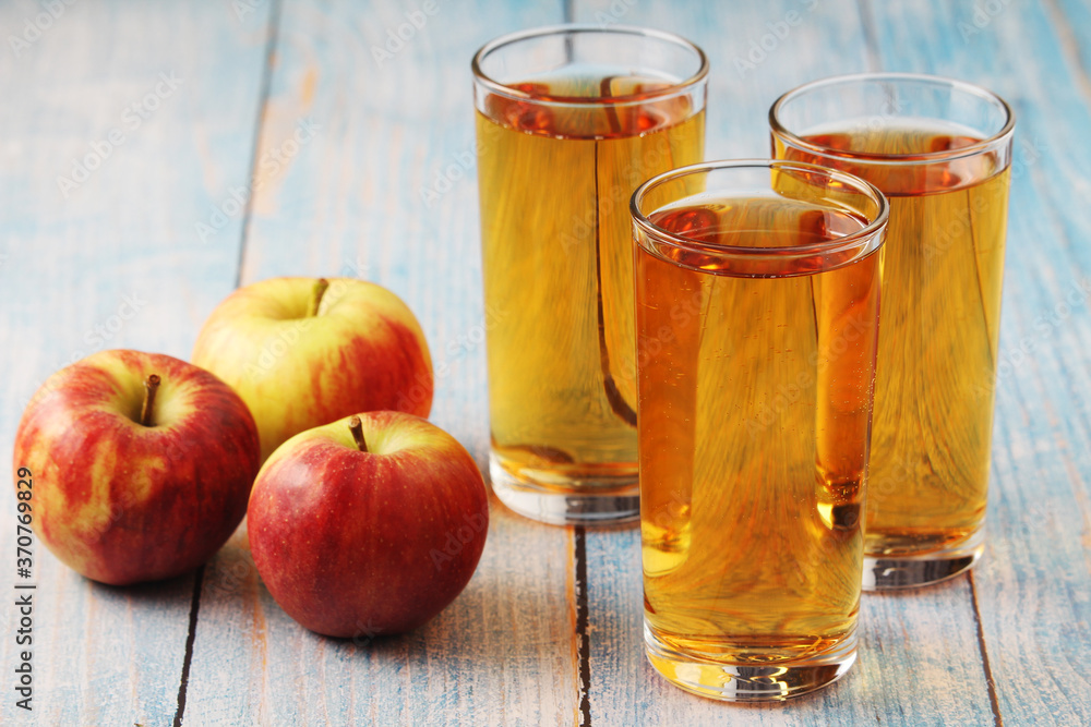 Glasses with apple juice and ripe apples Glasses with apple juice and ripe apples