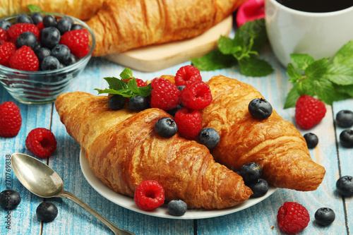 Croissants with fresh berries for breakfast	