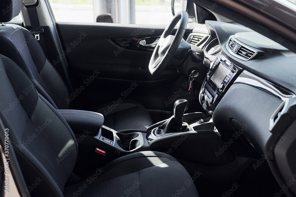 Steering wheel and front panel. Modern new luxury automobile interior. Design and technology
