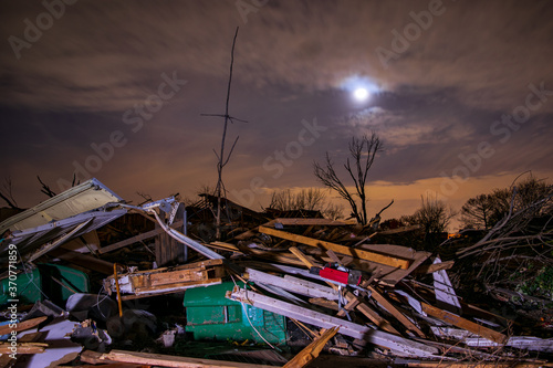 Tornado damage piles up at night