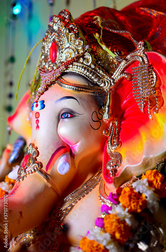 Low angle Close up shot of Hindu God Ganesha Chaturthi idol in a sitting position, Lord Ganesh. © jayant khedekar