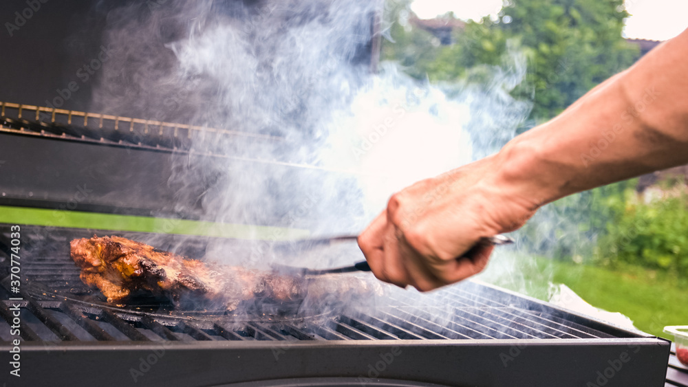 Home barbecue with charcoal in the backyard grilling steaks and other meats for carnivore diet. Home barbecue with charcoal in the backyard grilling steaks and other meats for carnivore diet.