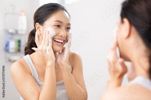Beautiful female asian Wash face in bathroom