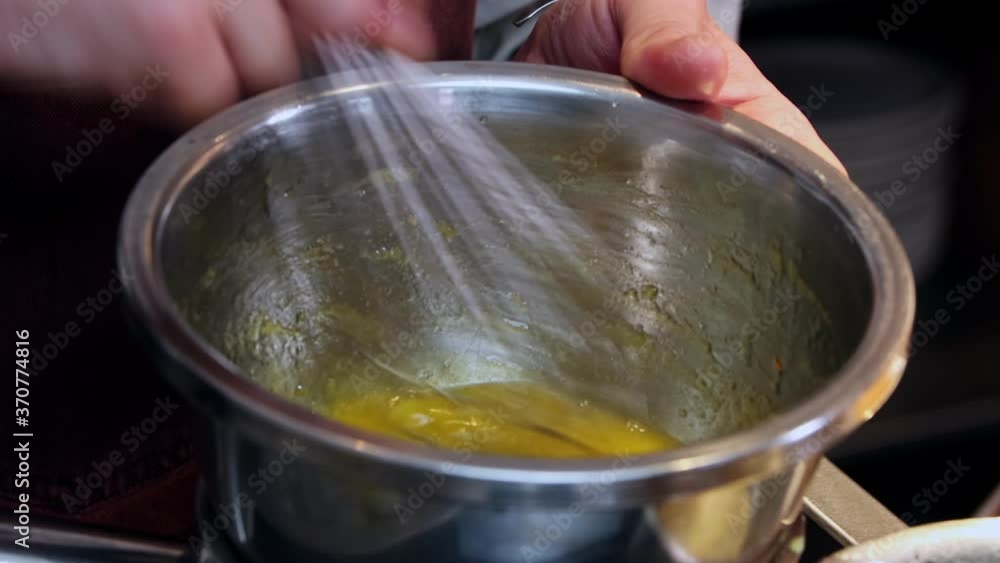 Restaurant kitchen from the inside - the chef making sauce with egg yolk Restaurant kitchen from the inside - the chef making sauce with egg yolk