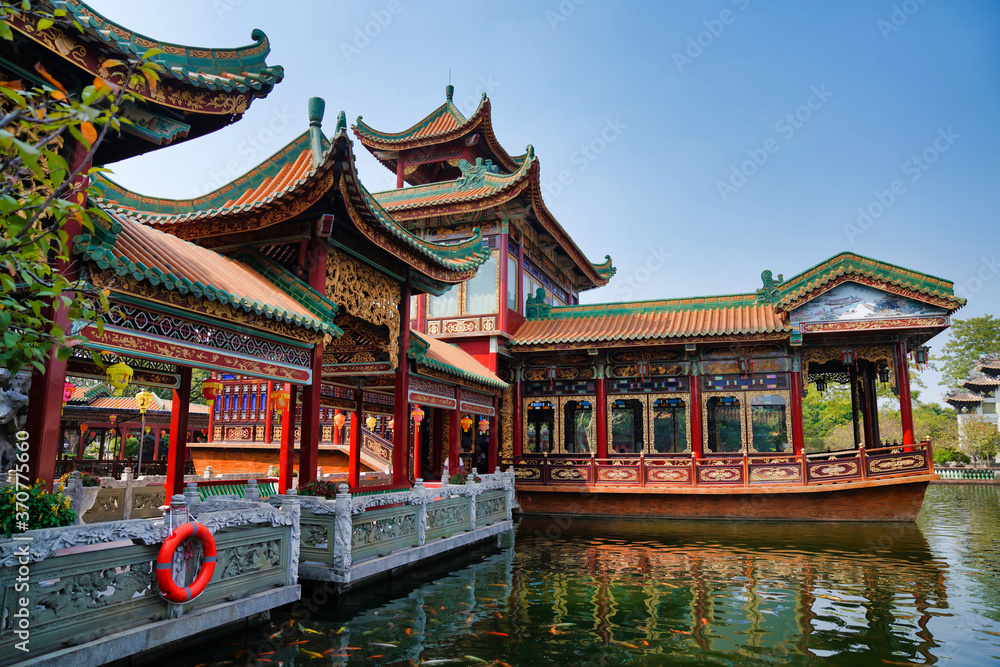 historic garden with traditional structures and popular water features filled with koi fish. Baomo park, Guangzhou China