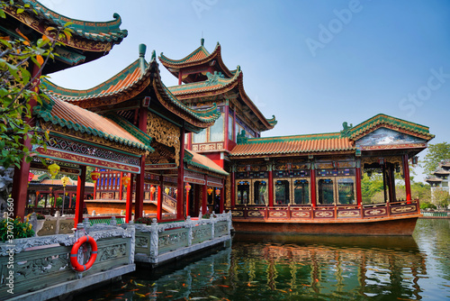 historic garden with traditional structures and popular water features filled with koi fish. Baomo park  Guangzhou China