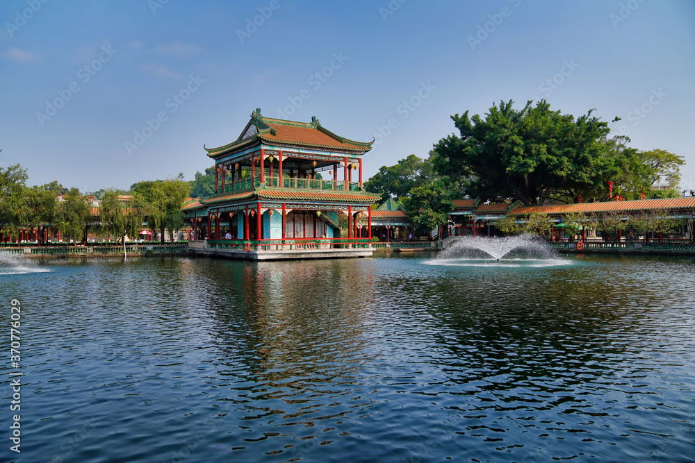historic garden with traditional structures and popular water features filled with koi fish. Baomo park, Guangzhou China	