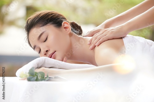 young woman relaxing while receiving oriental massage 