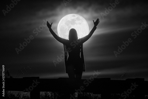 Silhouette of a woman standing on the moon