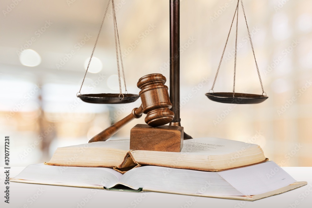 Justice scales and books and wooden gavel on the table. Justice scales and books and wooden gavel on the table.