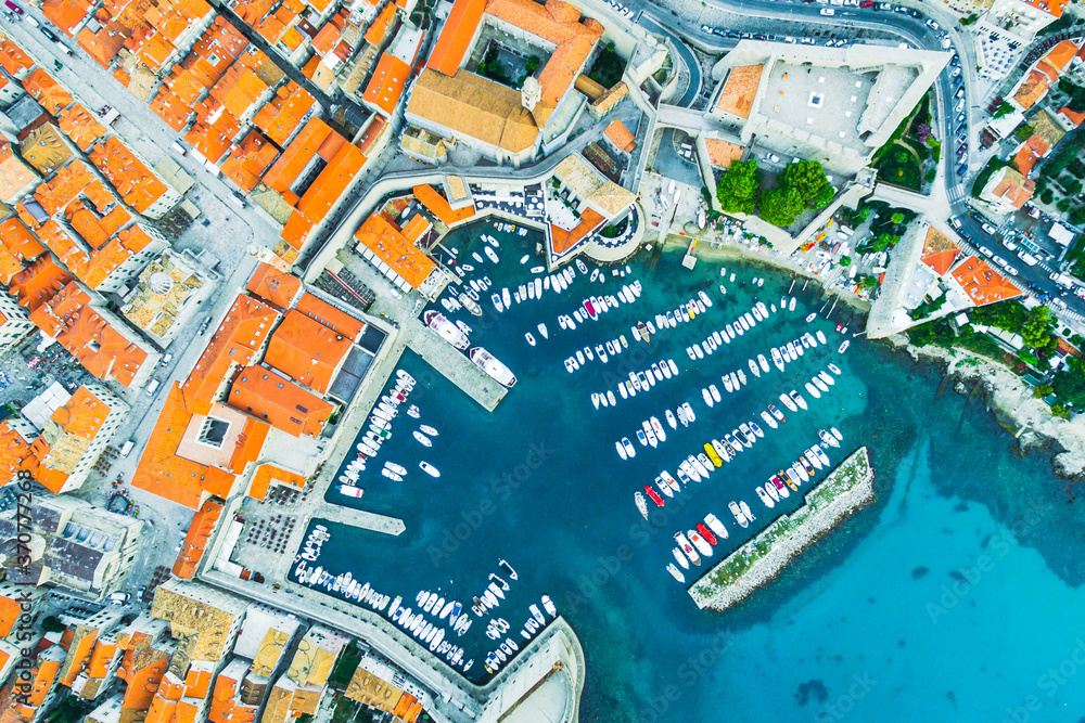 Obraz premium Aerial view down to the port of DUBROVNIK with many ships standing in a sunny day. Cruise and travel in Croatia.
