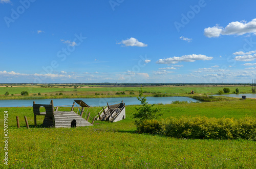 decorative wooden ship on a green field and blue sky