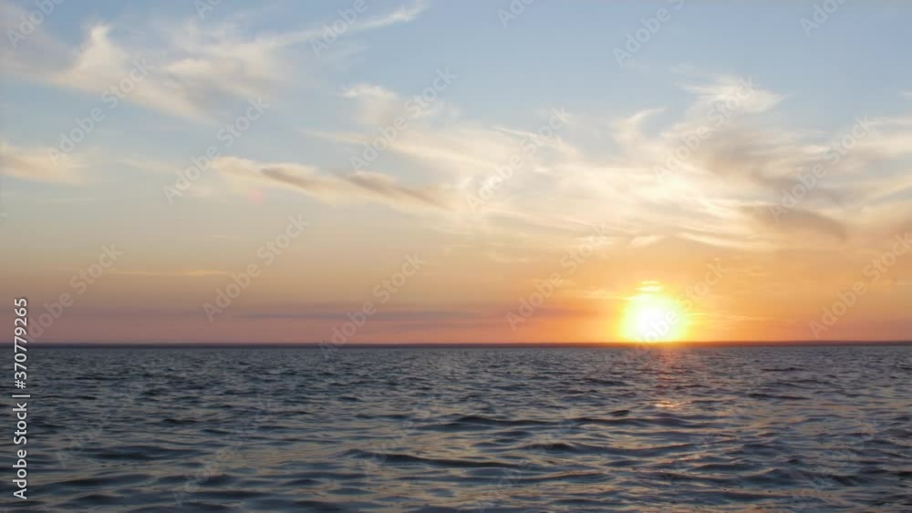 picturesque time lapse of sunset on sea,sun hiding behind horizon of water, clouds floating illuminated by sun rays in blue sky, nature background
picturesque time lapse of sunset on sea,sun hiding behind horizon of water, clouds floating illuminated by sun rays in blue sky, nature background