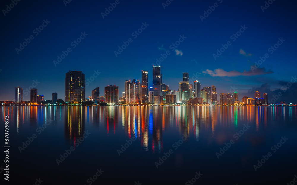 Fototapeta premium city skyline at night miami florida beautiful buildings reflection usa colors 