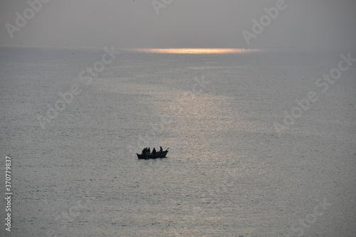 Sunrise inviting fishermen on a boat.