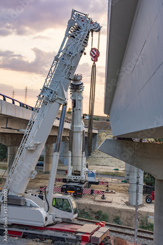 Crane trucks in the construction of a bridge