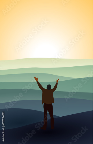 A man with hands raised in the sunset concept for religion, worship, prayer and praise