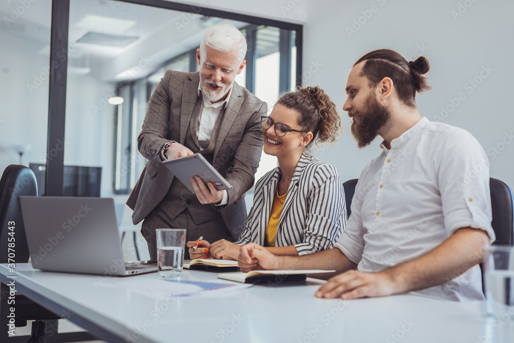 Group of business people sitting together and having a meeting in the office. Team of business people brainstorming. Group of business people sitting together and having a meeting in the office. Team of business people brainstorming.
