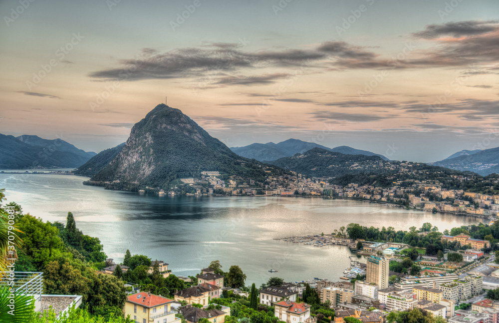 Early view of the lake of Lugano in Ticino, Switzerland. Sunrise during summer