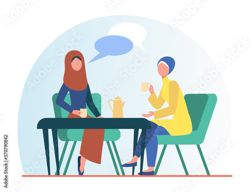 Muslim women meeting in Arabic coffee shop. Female friends wearing hijab drinking coffee flat vector illustration. Friendship, communication concept for banner, website design or landing web page