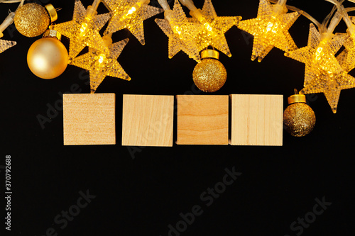 Four wooden blocks with deocrative stars. New Year concept photo