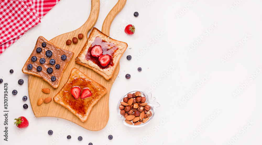 Peanut butter and jelly sandwich on a wooden board on a white background. copy space Peanut butter and jelly sandwich on a wooden board on a white background. copy space